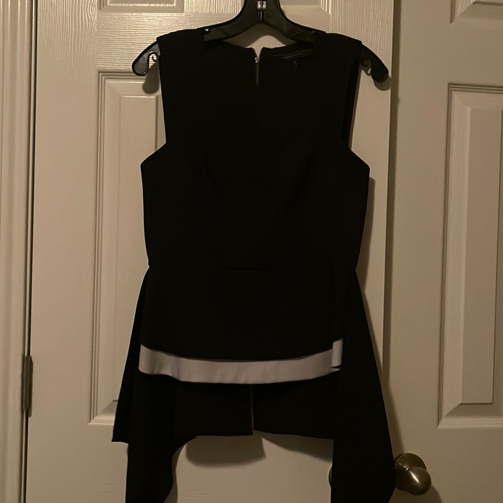 Black structured peplum with white trim across the bottom